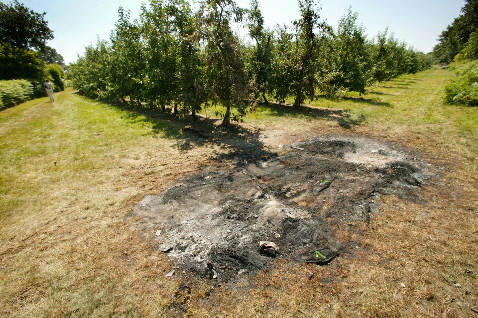 De uitgebrande auto werd aangetroffen in een fruitplantage in Nieuwerkerken. 